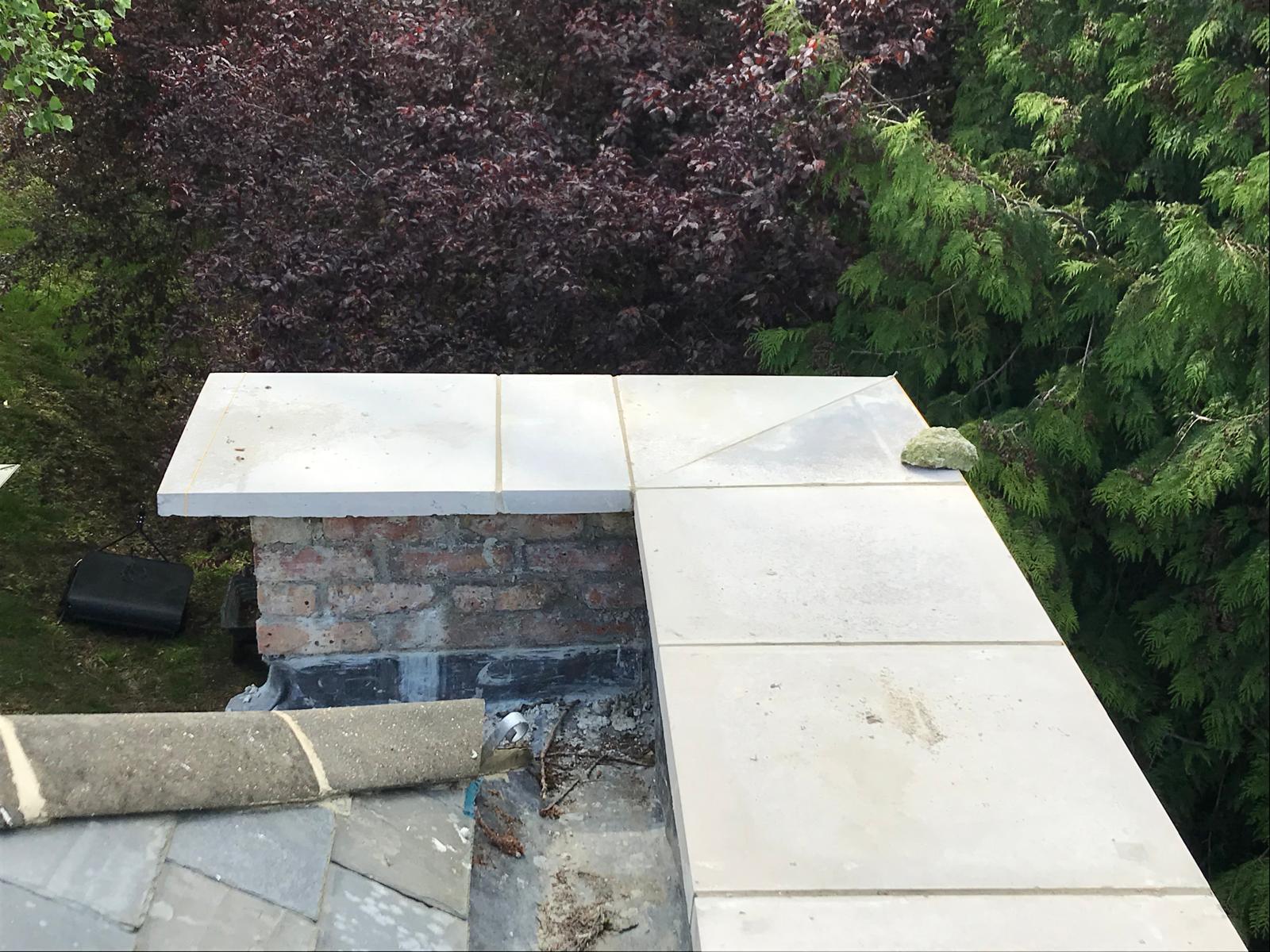 Slab installation on top of natural stone wall