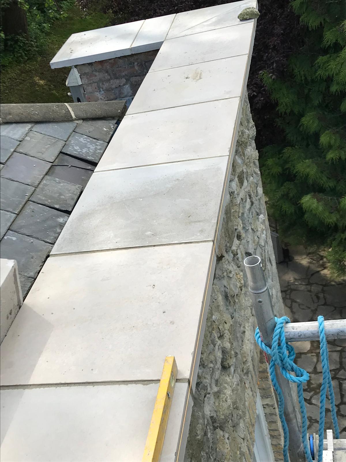 Slab installation ontop of stone wall for extension project