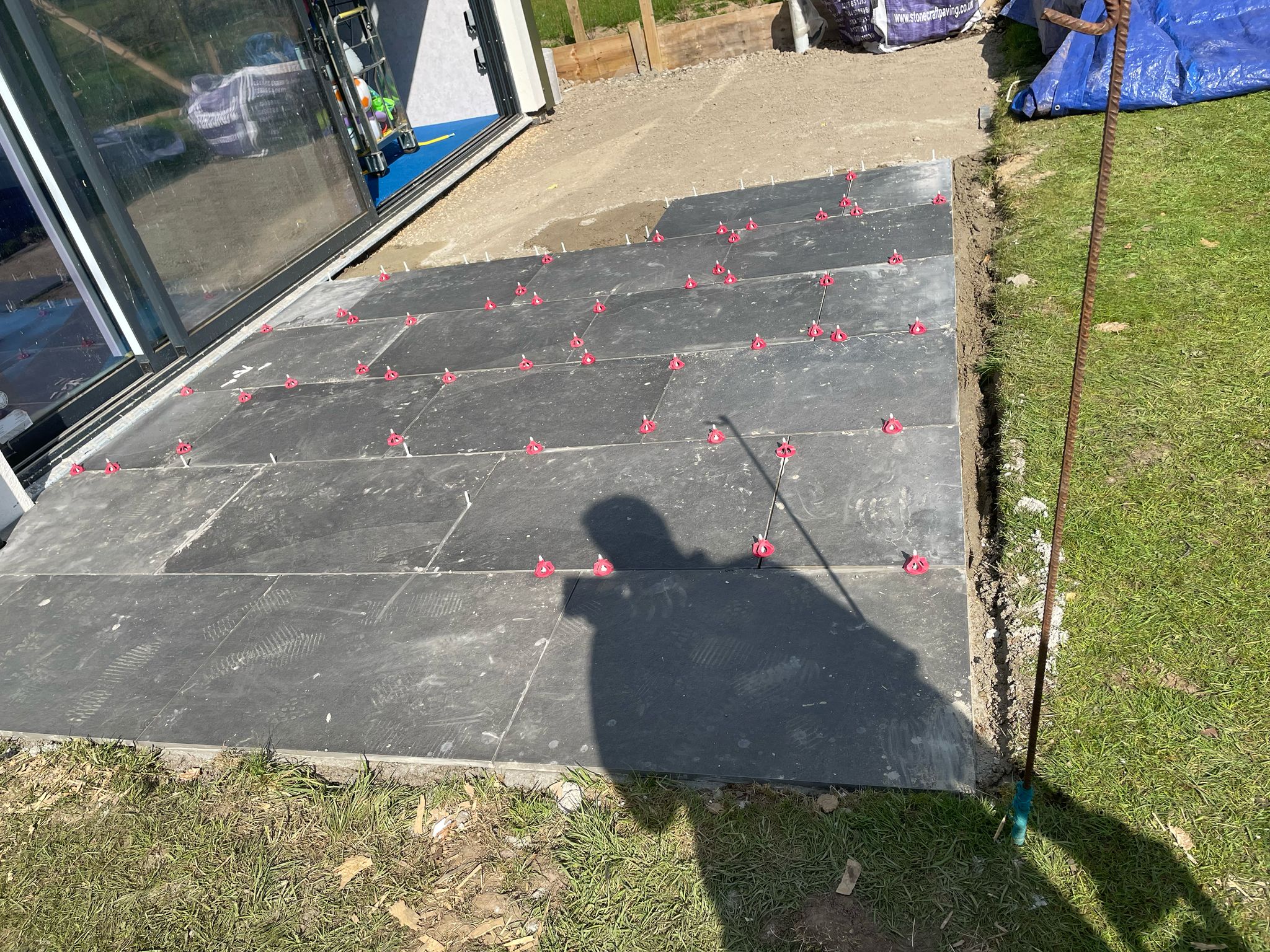 Slabs being laid outside the front of the swimming pool building