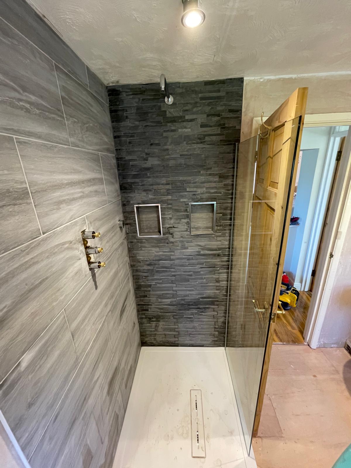 Slate effect wall tile installation in a shower area 