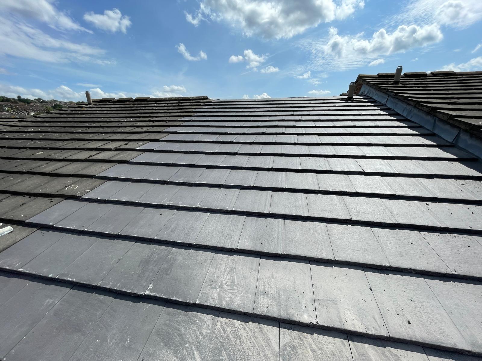 Slate roof tile installation on a partial roof repair project