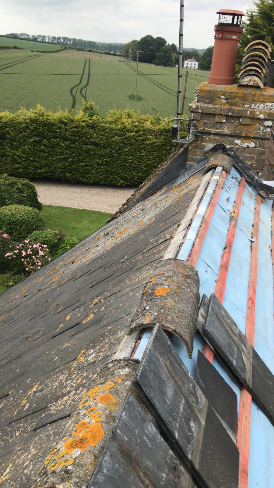 Slate roof tile installation ridge tiles being installed