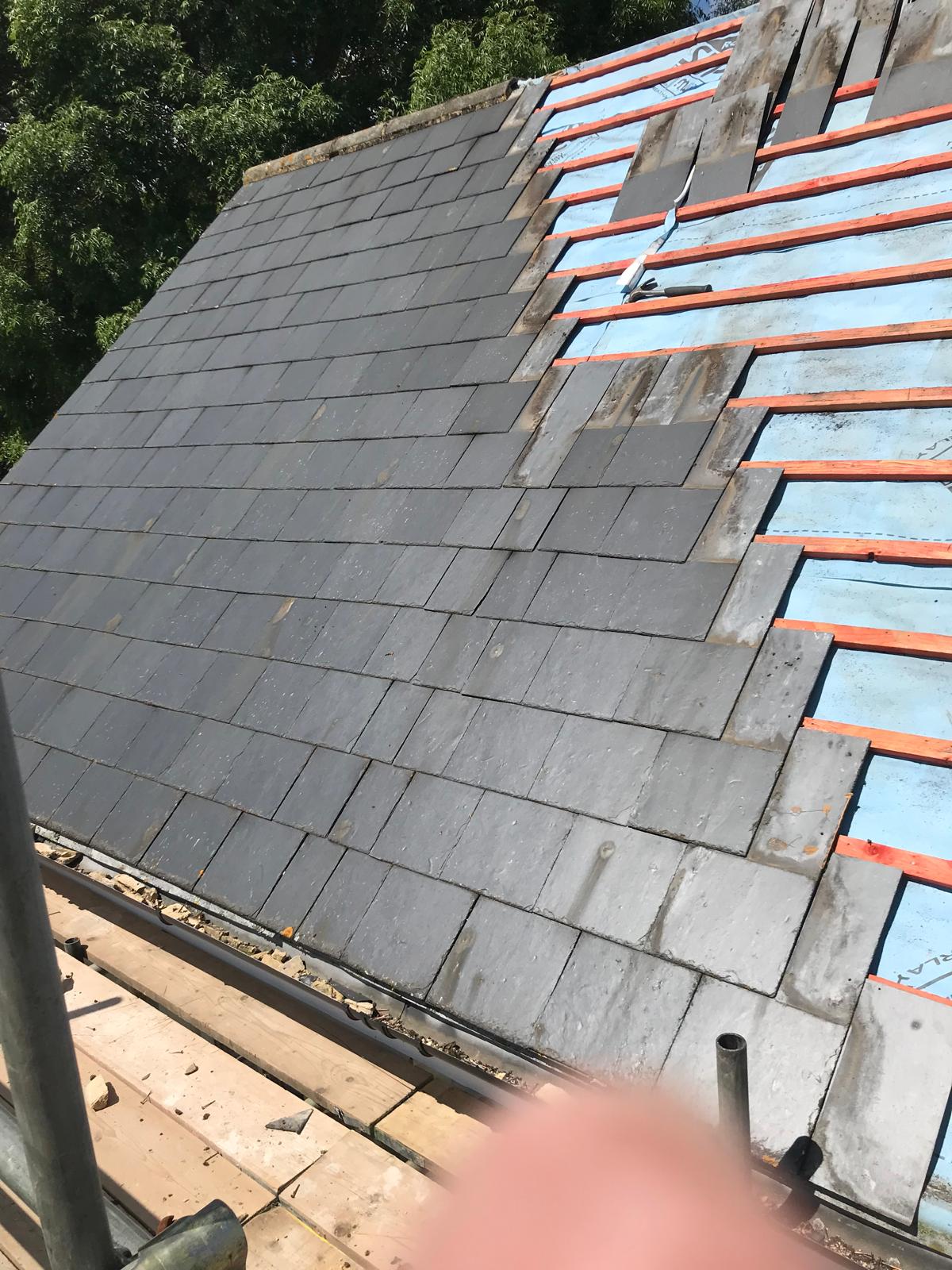Slate roofing tiles being installed on a roofing project in Kent