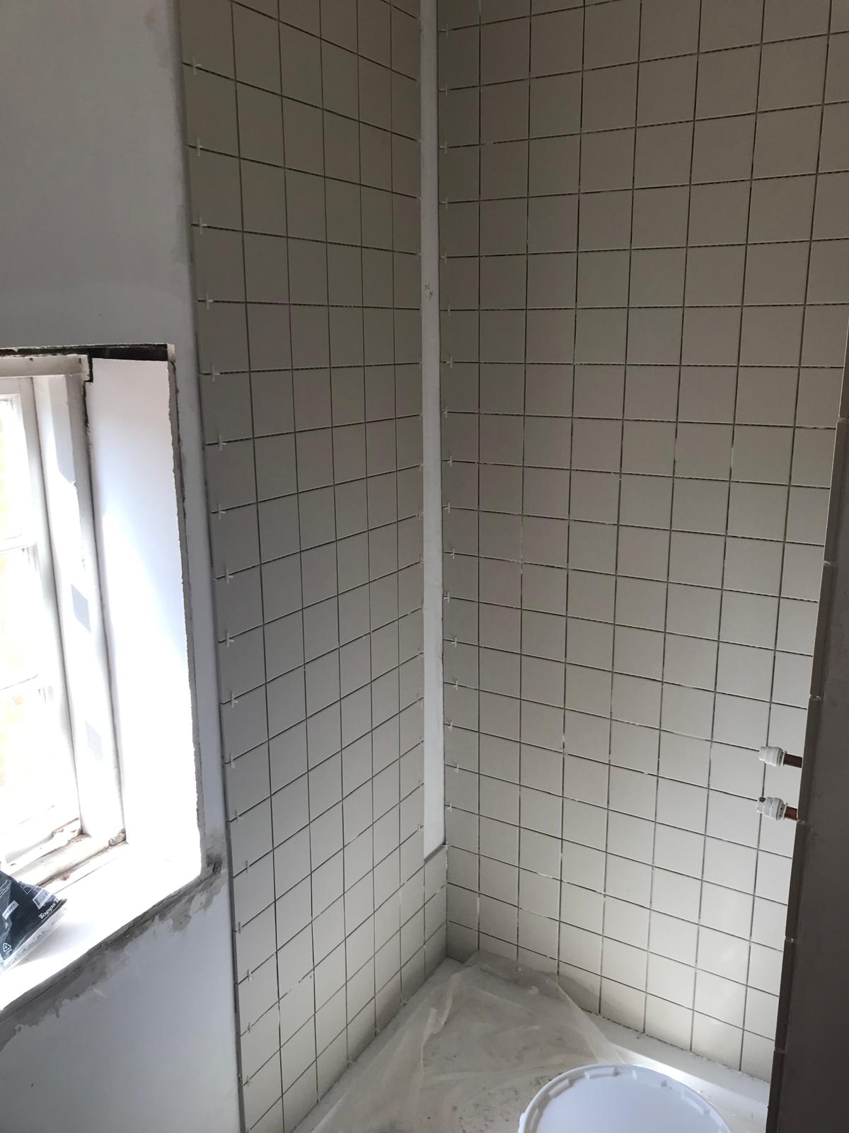 Square white tile installation for a bathroom project in Kent 
