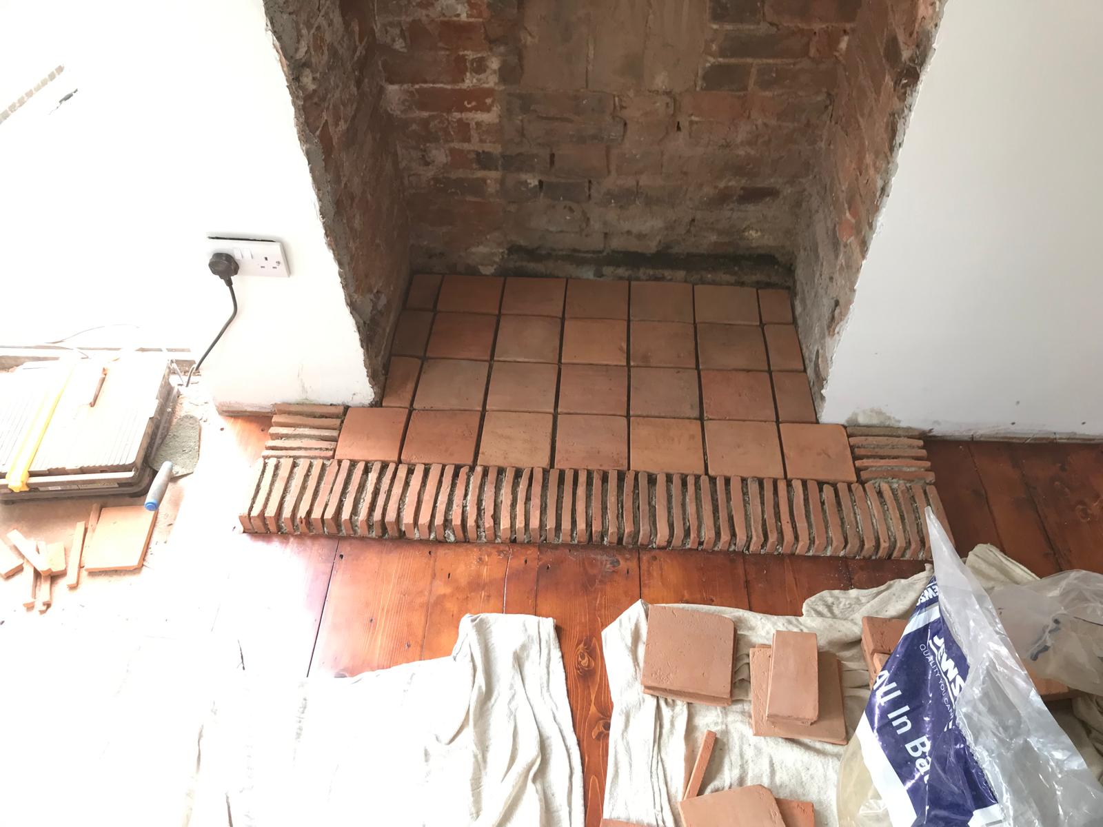 Terracotta tile installation i fire place for a loacl decorating project