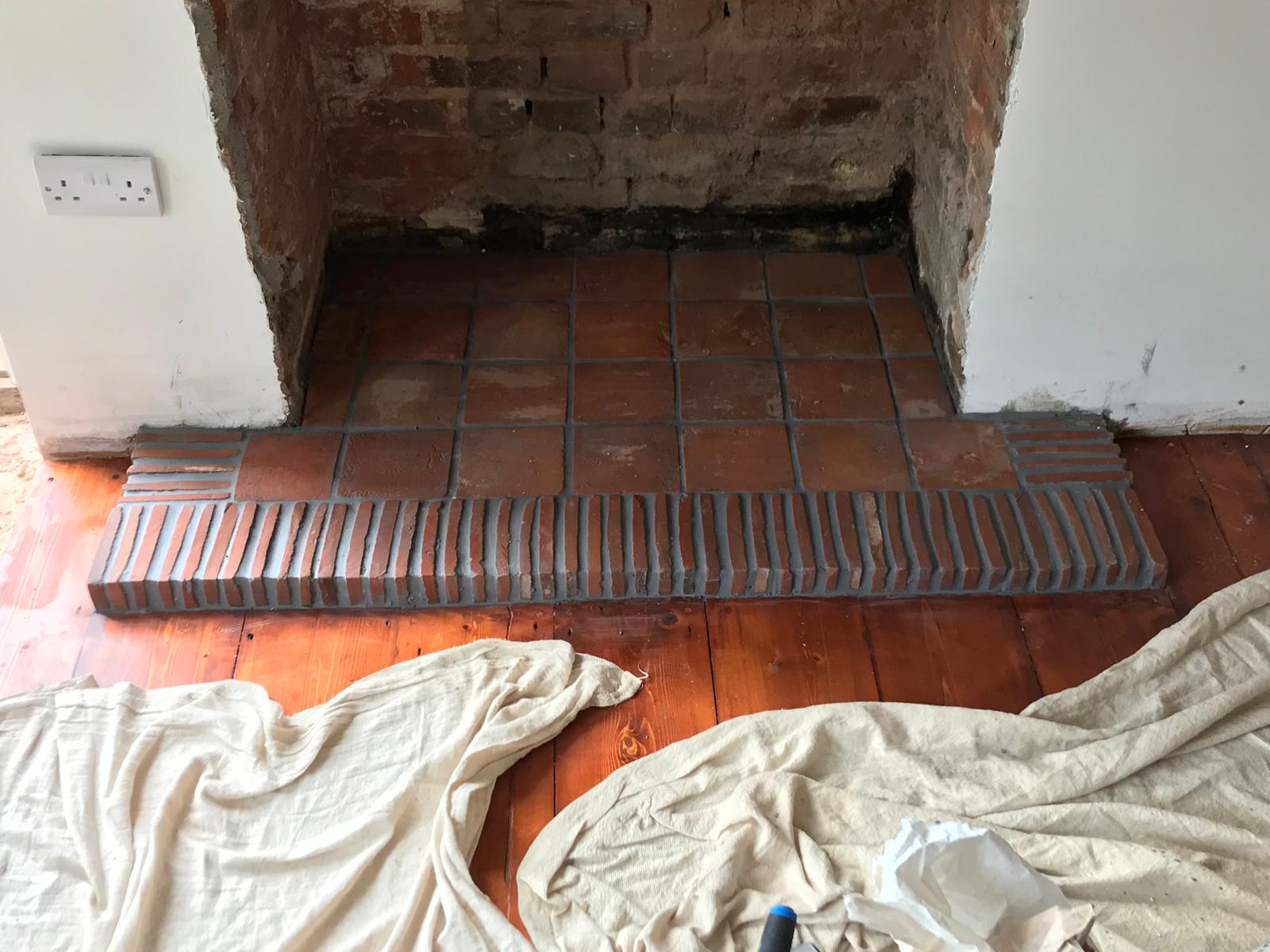Terracotta tiles installed in fire place