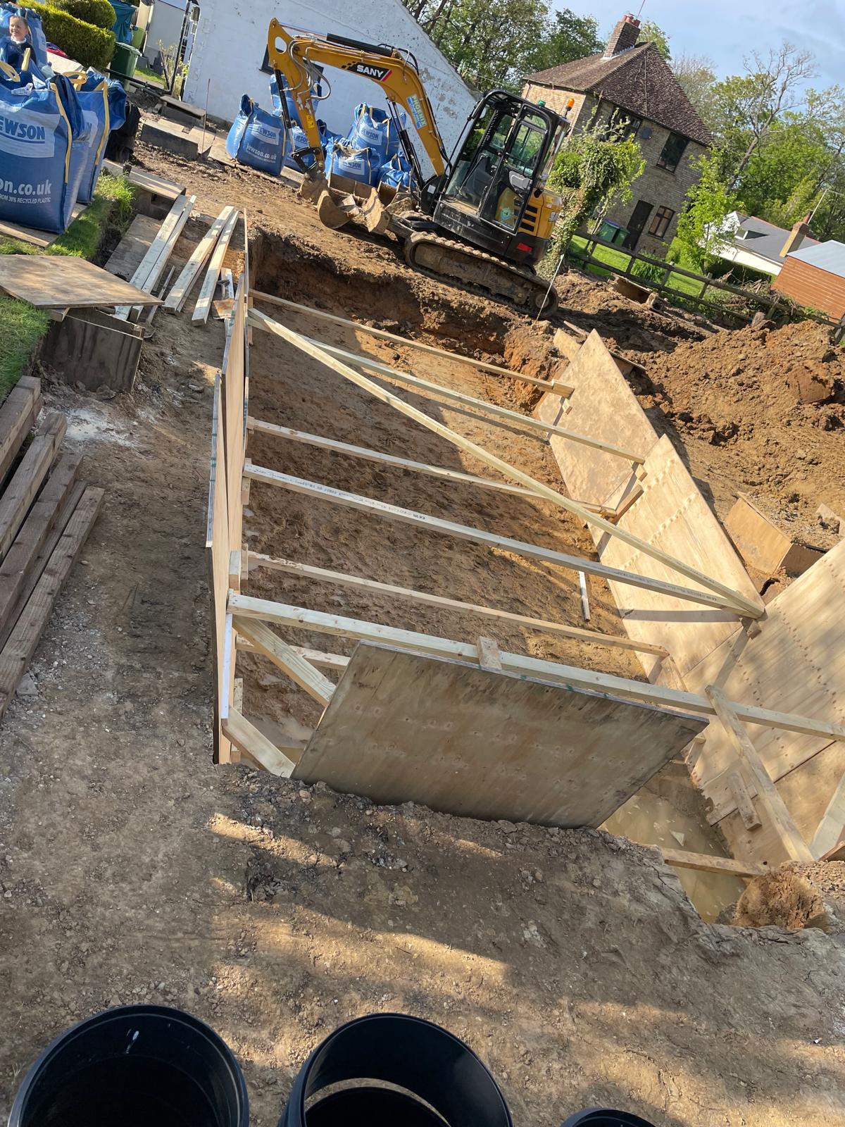 Timber supports installed to reinforce swimming pool excavation