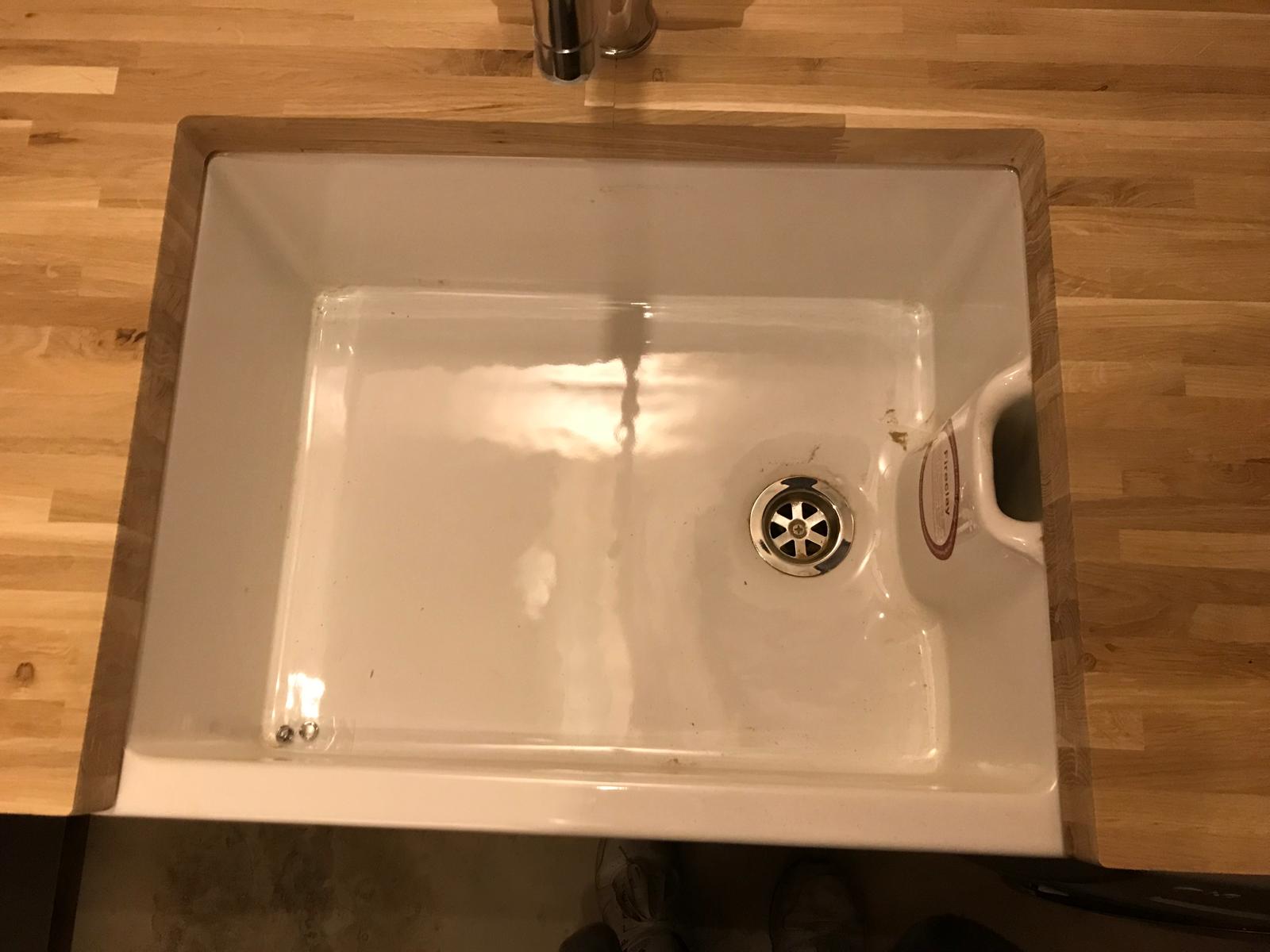 Utility room sink installation with drain