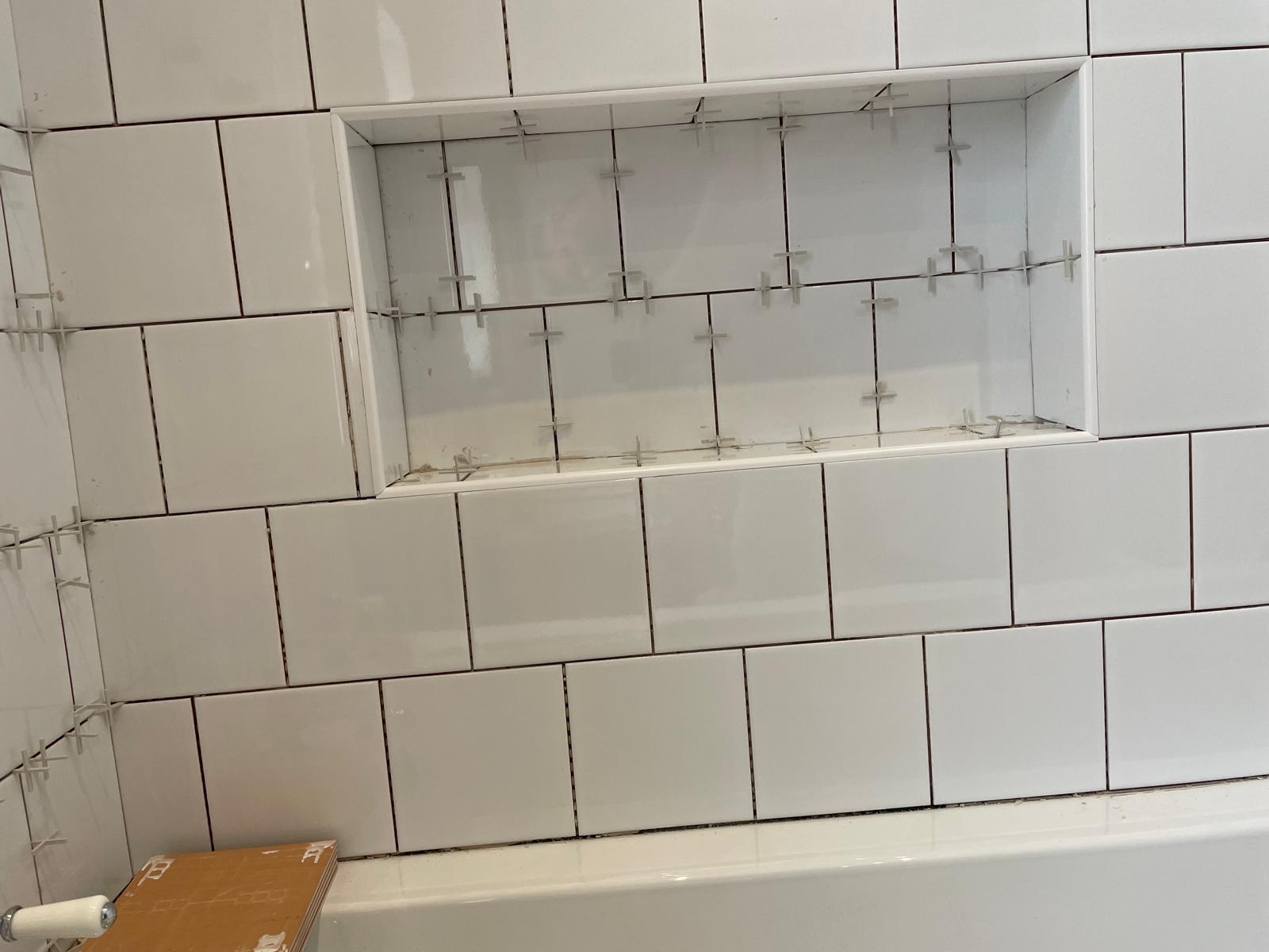 Wall shelving area tiled above bath area for a local bathroom project 