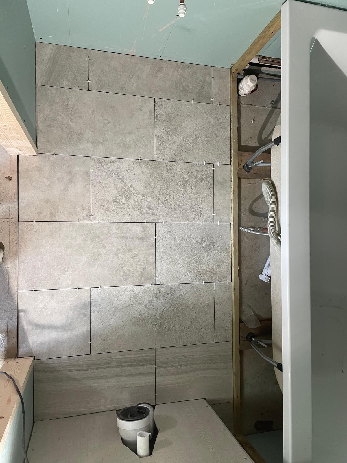 Wall tile installation in bathroom area on a conversion project