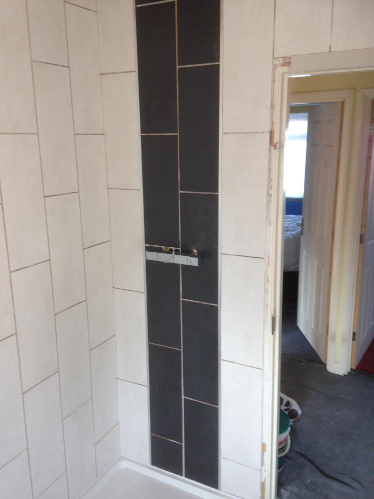 White and black bathroom wall tile installation 