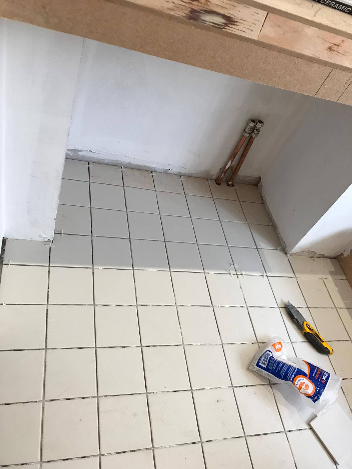 White floor tile installation for a bathroom project