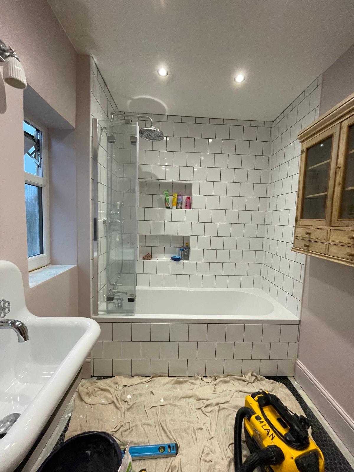 White square wall tile installation on walls and bath for a local bathroom re fit project in Kent 