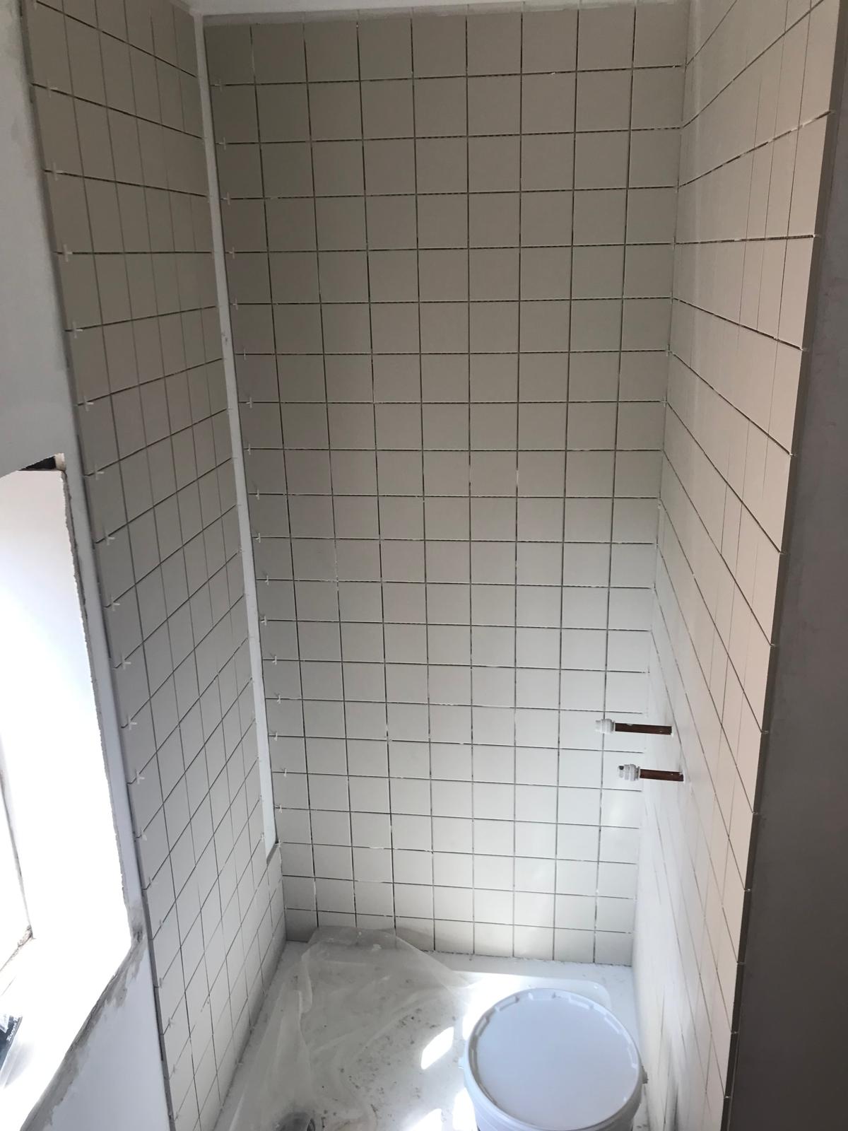 White tiled shower area from a bathroom project 