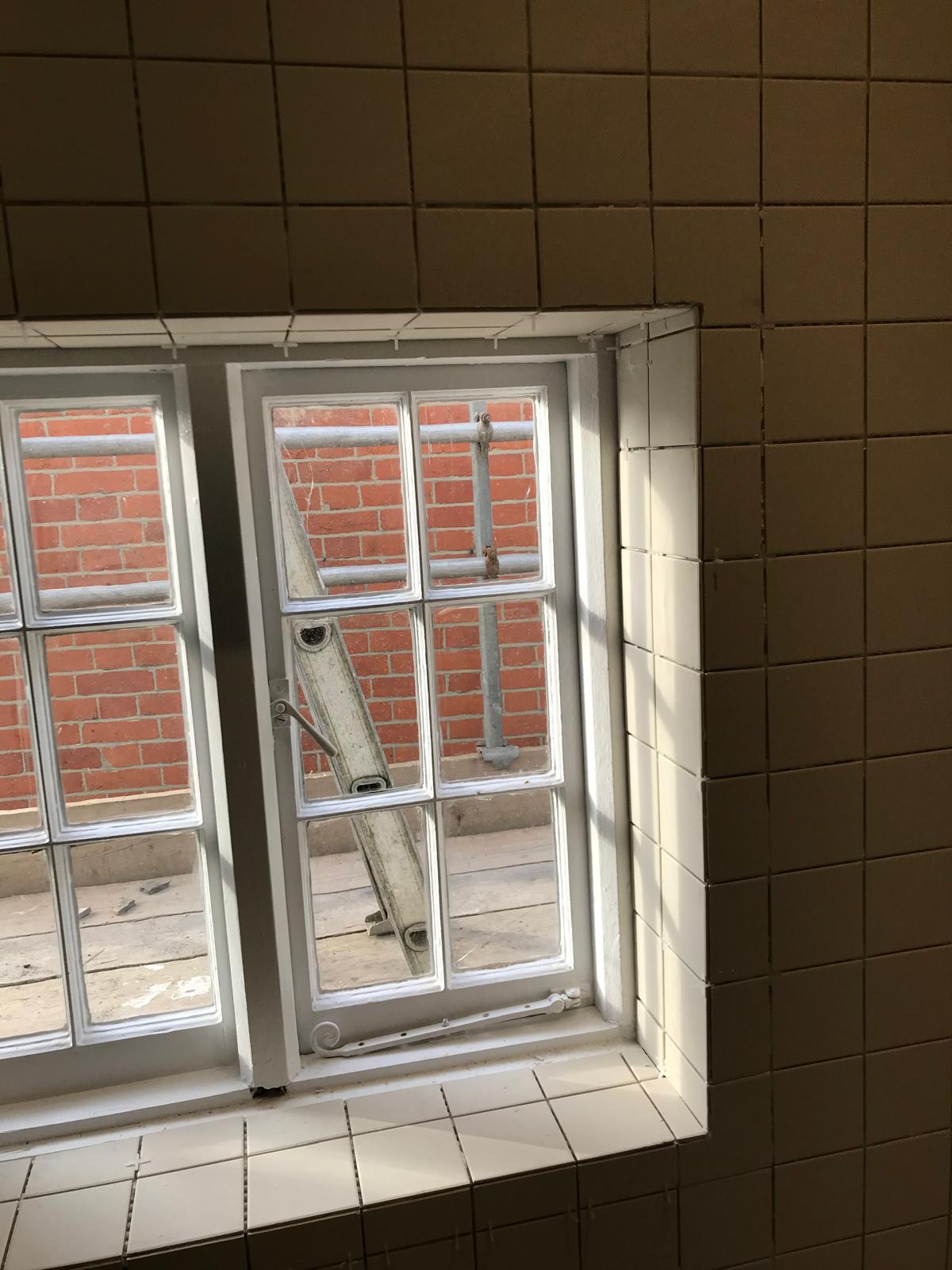White wall tile corner installation on a bathroom project