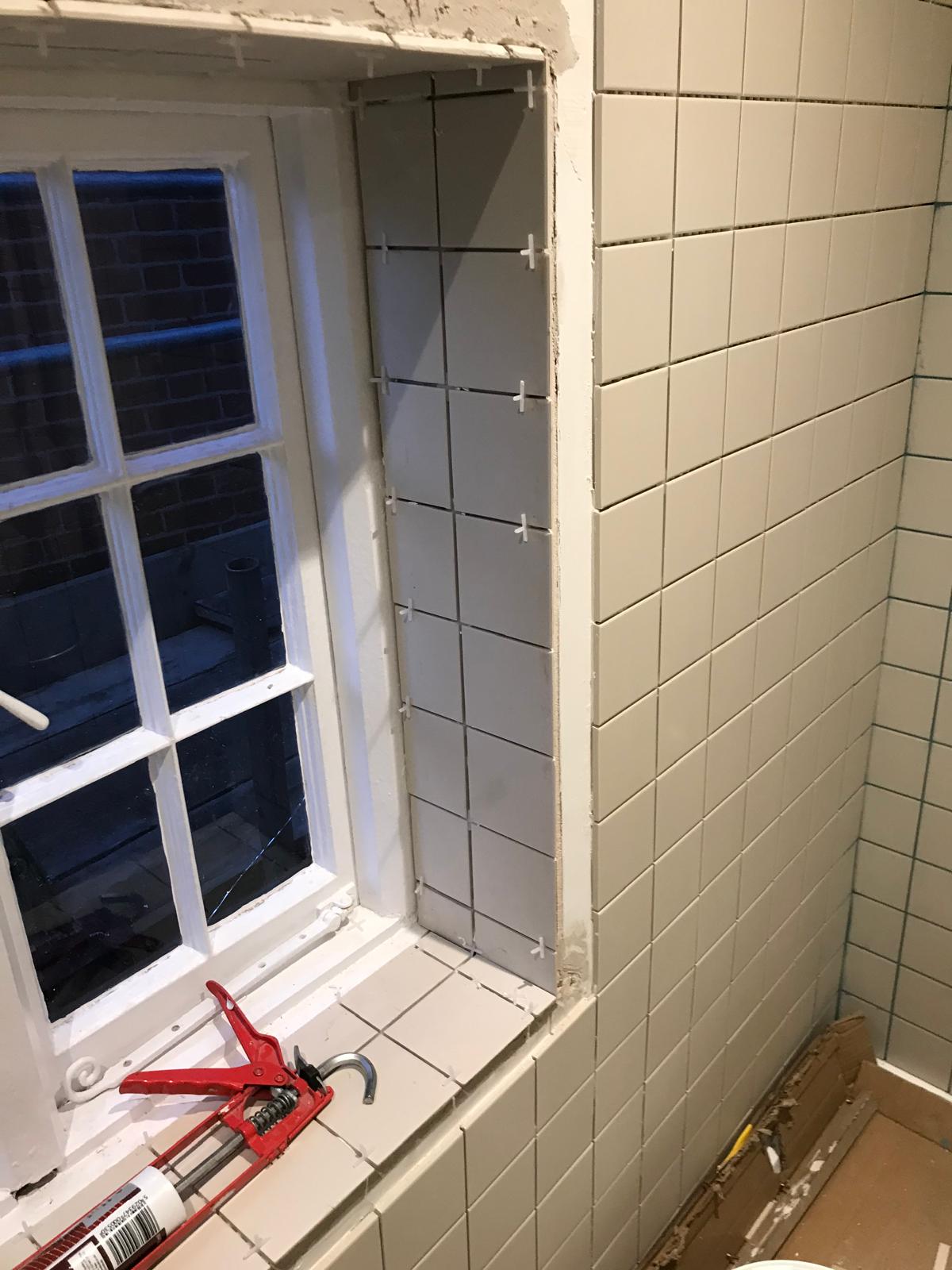White wall tile installation inside window area for a local bathroom project