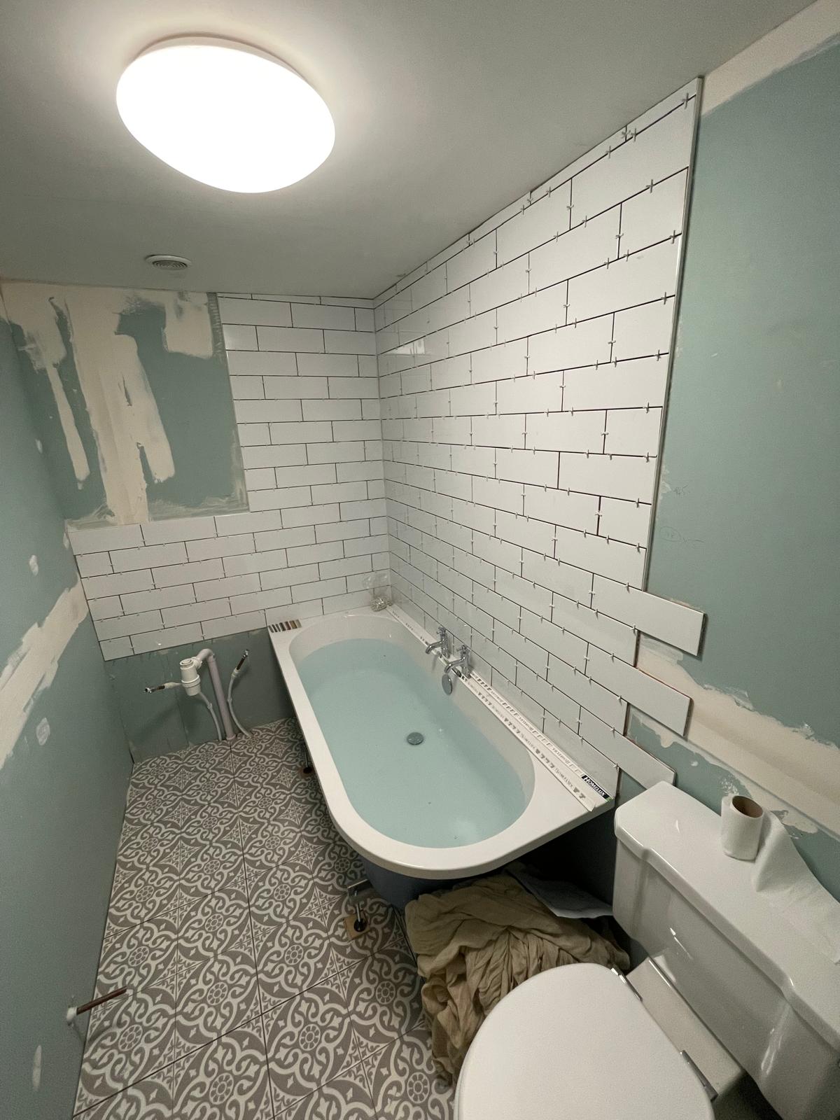 White wall tile installation on local bathroom project 