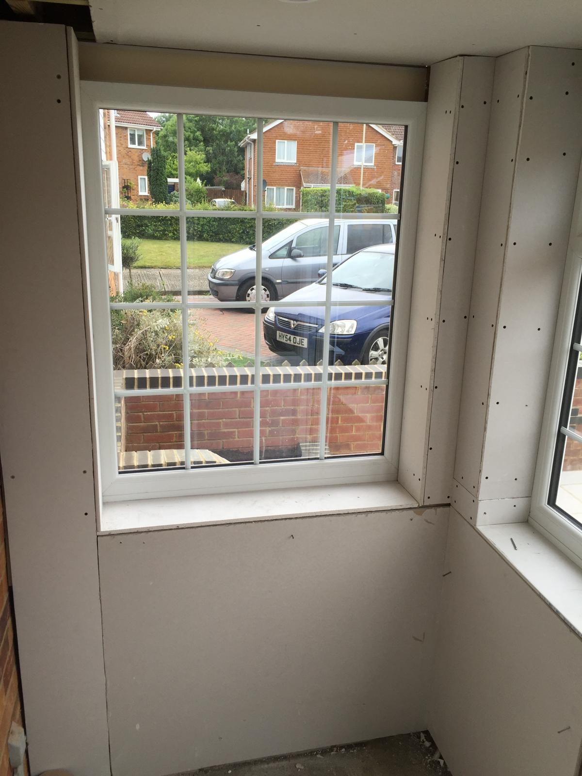 Window installation on a porch extension project