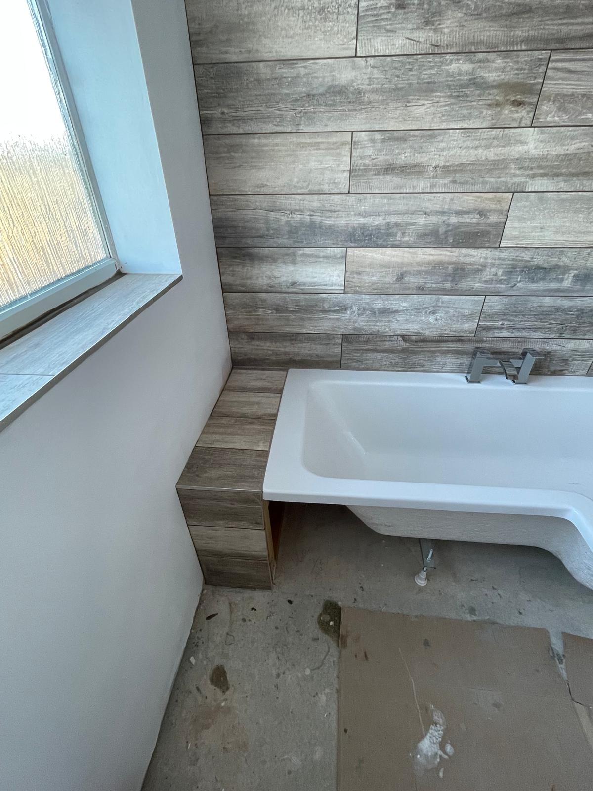 Wooden tile effect installed at end of bath