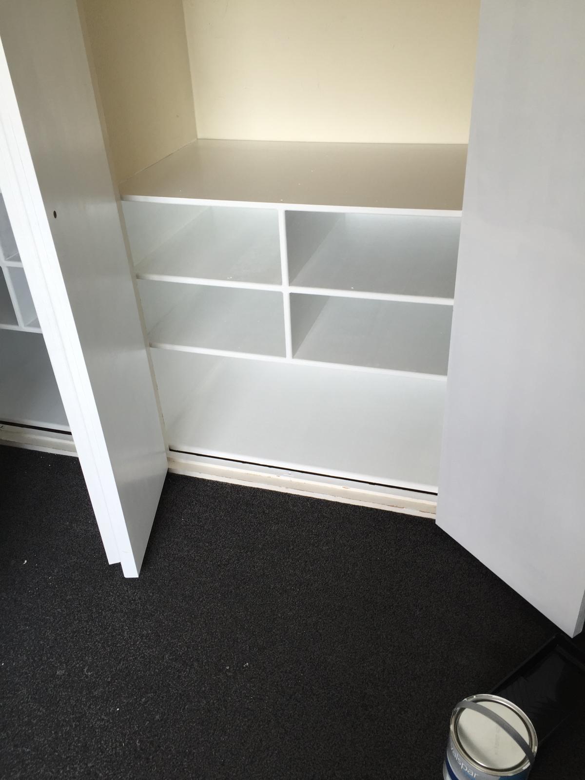 bespoke shelving built and painted inside a wardrobe